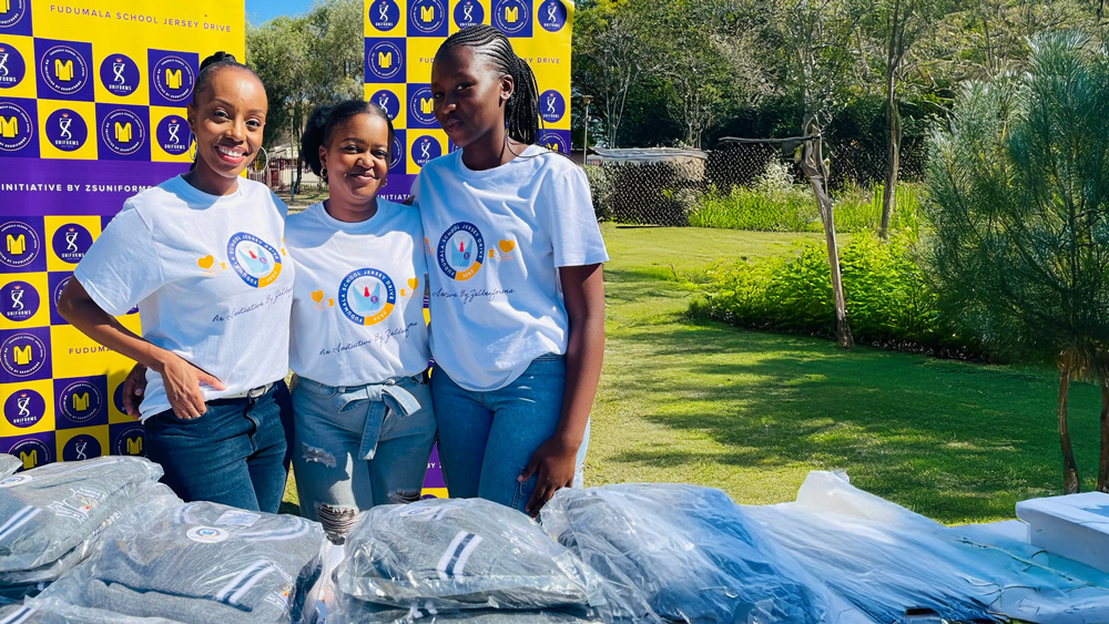 Students receiving winter jerseys during Fudumala Jersey Drive